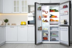 Open refrigerator in the middle of a modern kitchen setup