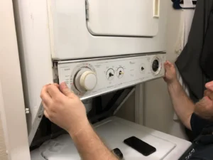 Technician repairing stacked washer