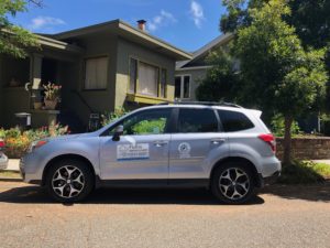 A FixEm technician's car outside of a customer's home