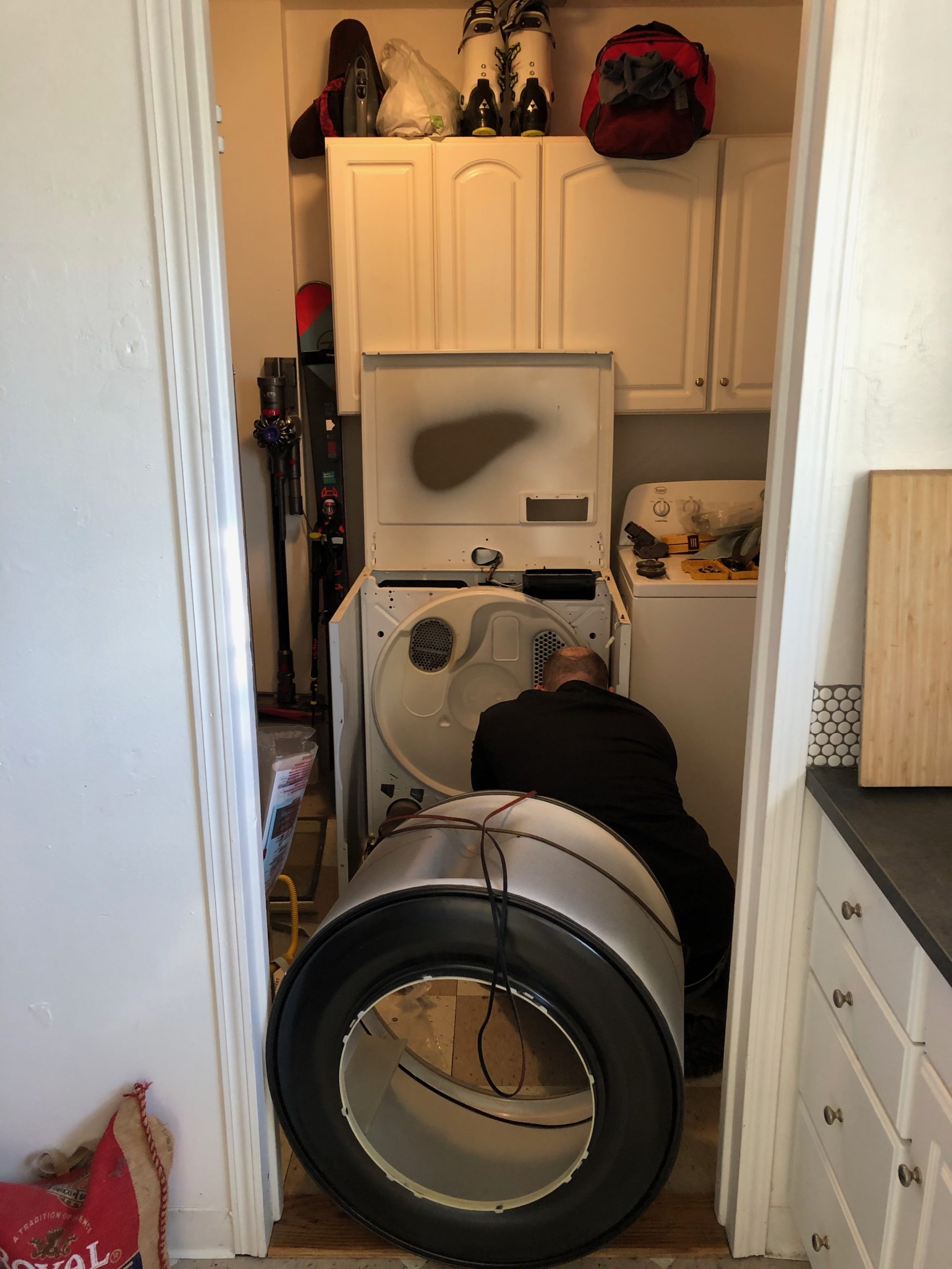 A technician repairing a dryer