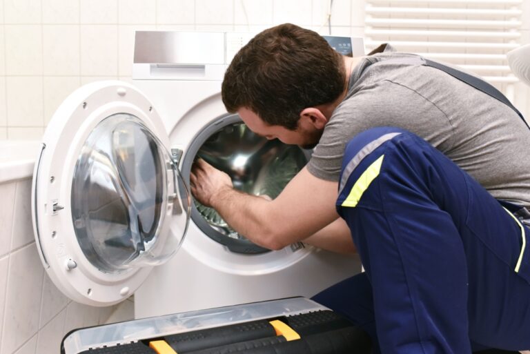 A technician repairing a dryer.