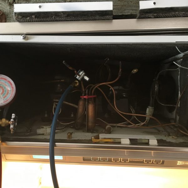 Checking refrigerant cooling levels.