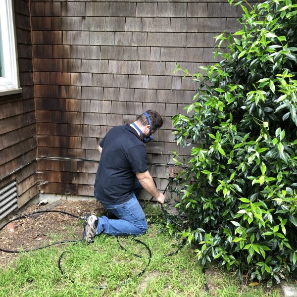 A technician cleaning a dryer exhaust vent.