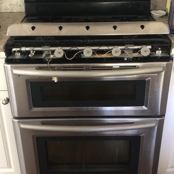 A Maytage oven in the middle of repair.