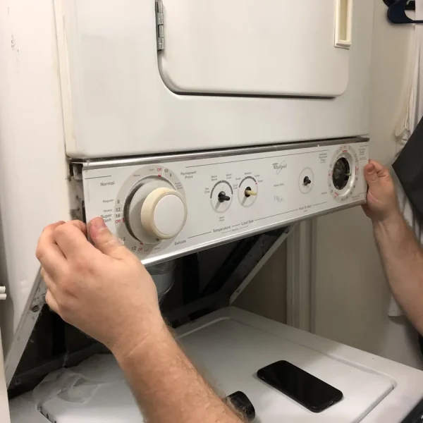 Technician repairing stacked washer